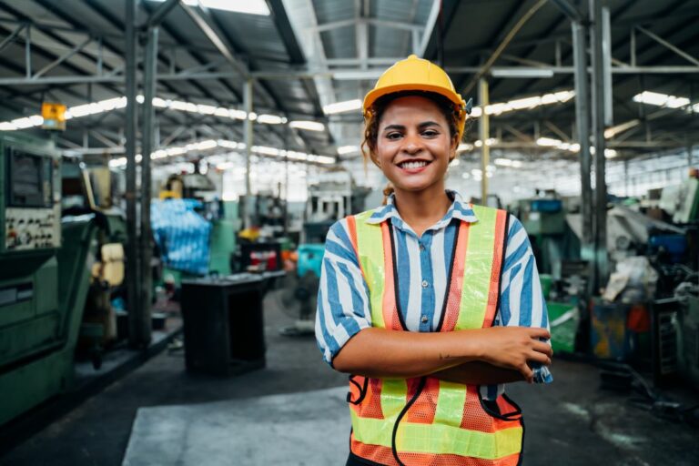 Young female energy worker on the job wearing a hard had and safety vest